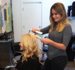 Victoria creating beach waves with a flat iron.